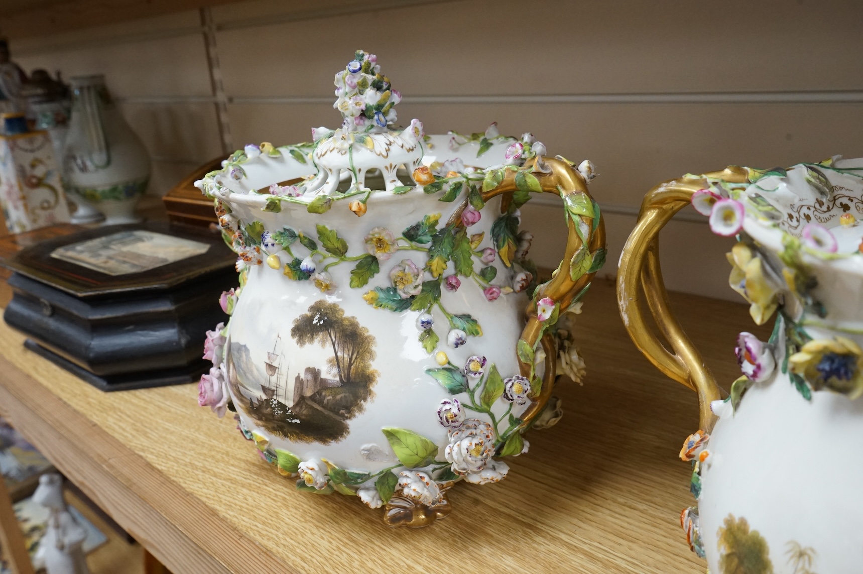 A pair of Rockingham two handled pot pourri vases and covers, c.1830-42, the first painted with two named views near Lyme, Dorsetshire and Stockly Bridge’, The second with an unnamed view of a monument by a lake, the rev